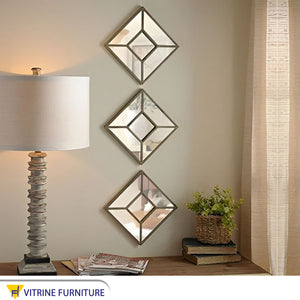 Three square mirrors arranged vertically