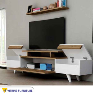 TV unit with movable hinged surfaces