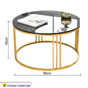 Coffee table with round base in gold
