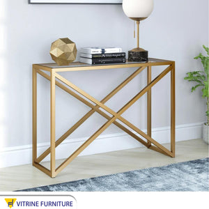 Gold console with an x-shaped structure