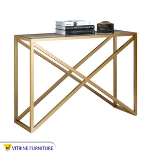 Gold console with an x-shaped structure