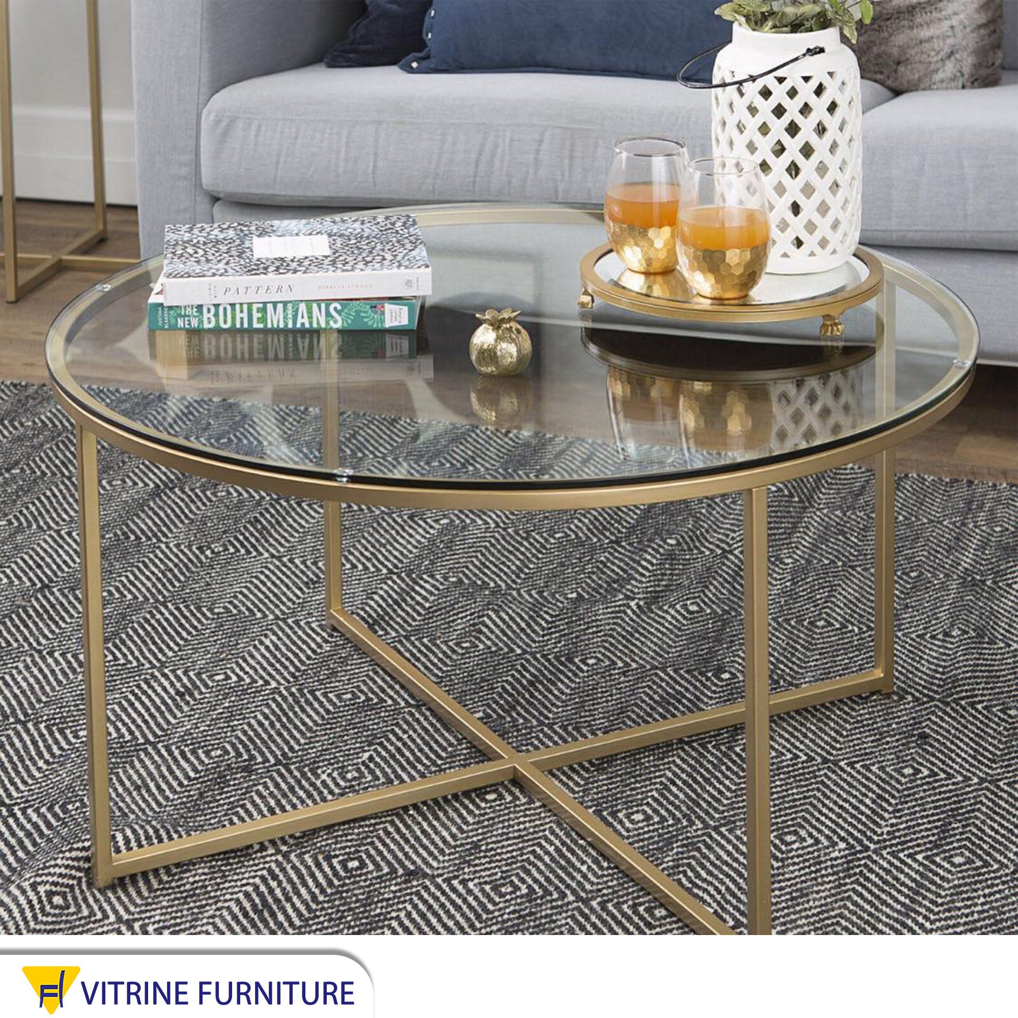 Circular table with a gold x-shaped base