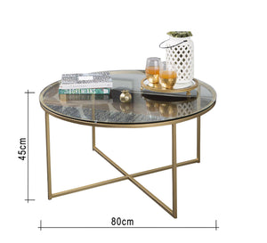 Circular table with a gold x-shaped base