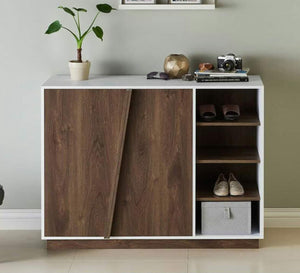 A shoe cabinet with slanted hinged doors and open shelves