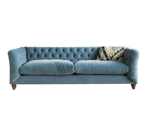 Blue sofa with capitone beads