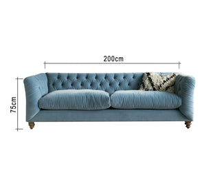 Blue sofa with capitone beads