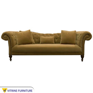A sofa with twisted cylindrical armrests