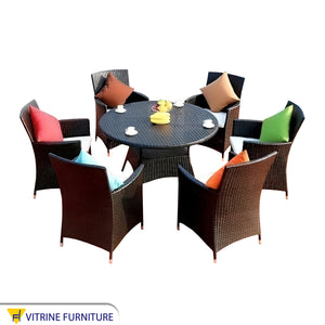 Circular rattan table with eight chairs