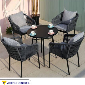 Four gray chairs and a table for the terraces