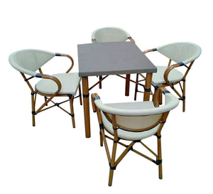 A small dining table with four chairs and a table