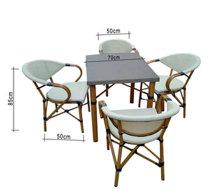 A small dining table with four chairs and a table