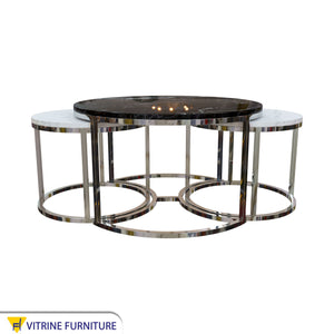 Three silver tables with black and white marble