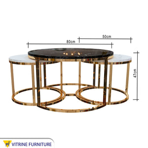 Three golden tables with black and white marble