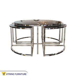 A circular table with four small silver tables