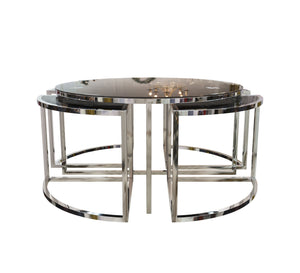 A circular table with four small silver tables