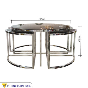 A circular table with four small silver tables