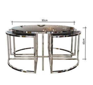 A circular table with four small silver tables