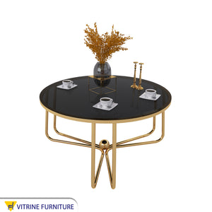 Circular table with three interlocking legs