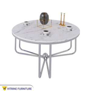 Circular table with three-legged chassis