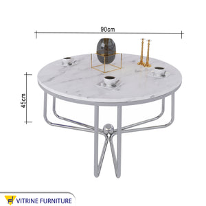 Circular table with three-legged chassis