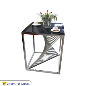 Table with a cube frame and a black glass top