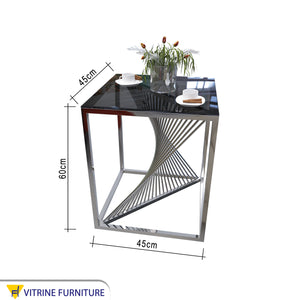 Table with a cube frame and a black glass top