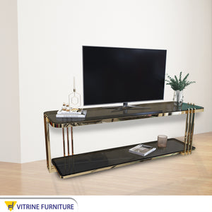 A rectangular gold TV table with two shelves