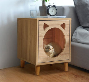 Beige wooden side table and cat house