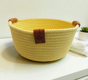 Low round basket with leather handles and cheerful colors
