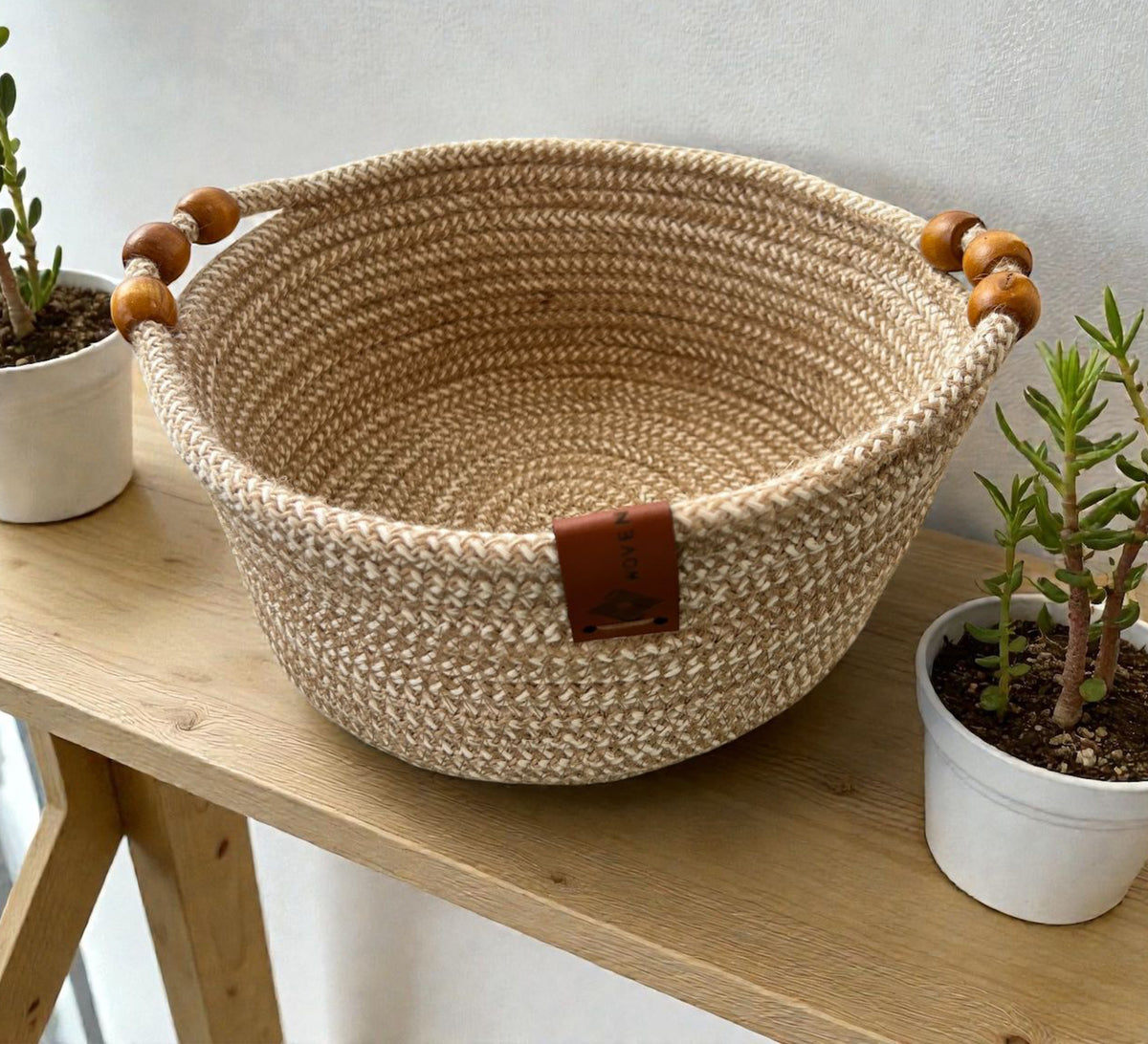 Low round basket with leather handles and cheerful colors