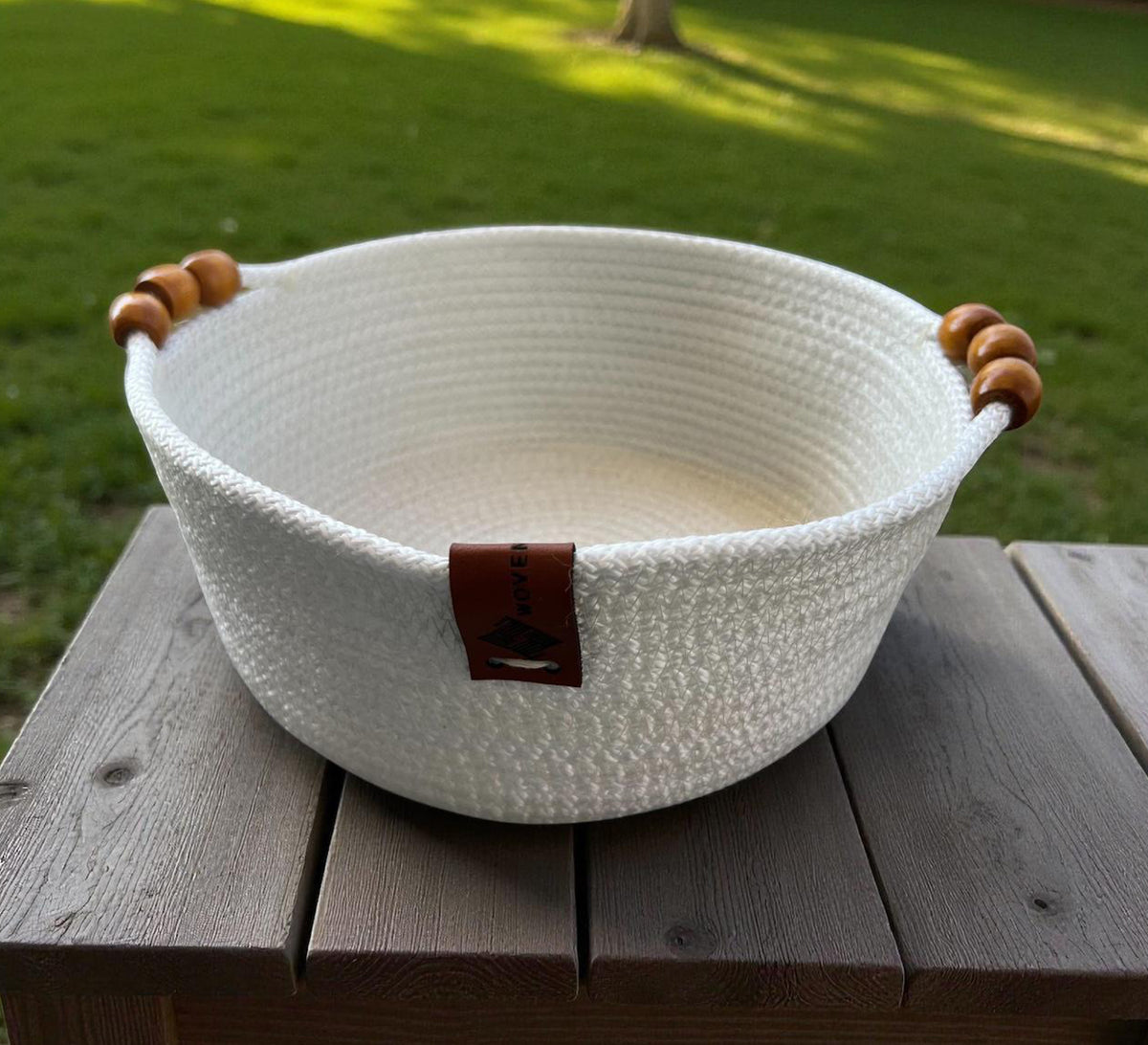 Low round basket with leather handles and cheerful colors