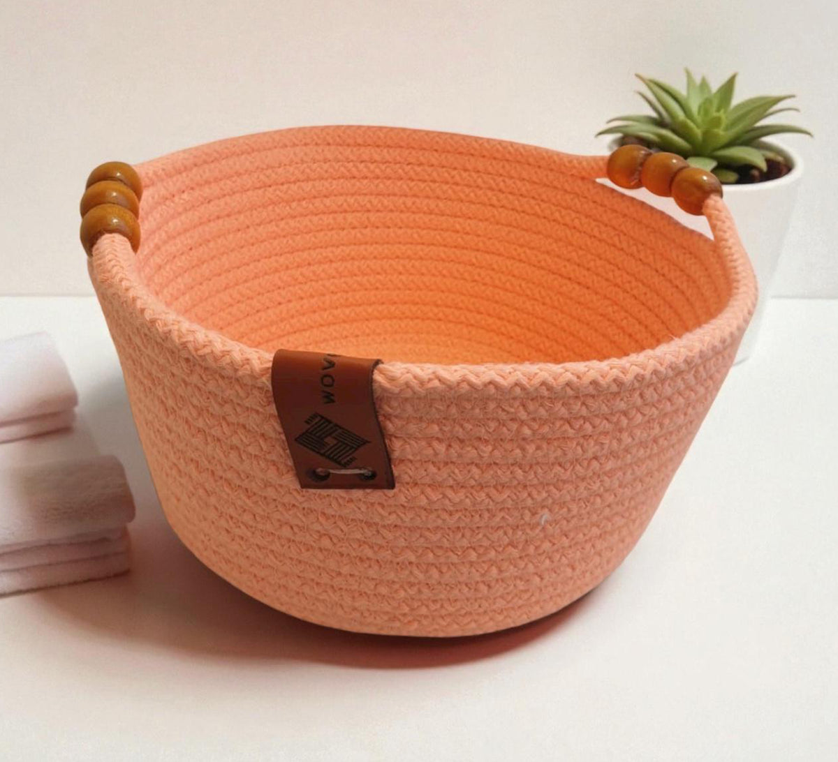 Low round basket with leather handles and cheerful colors