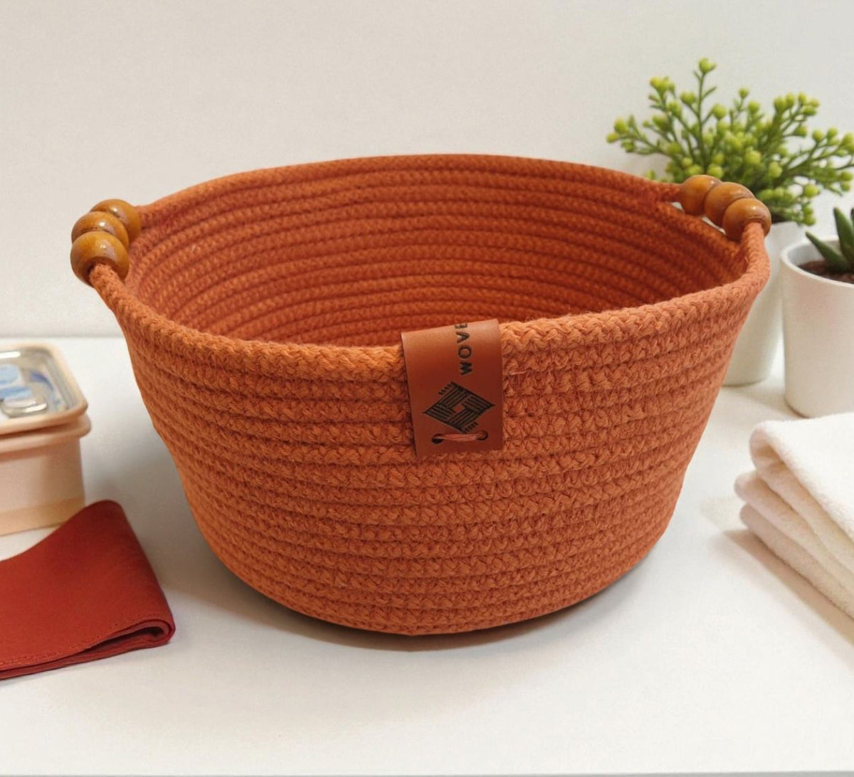 Low round basket with leather handles and cheerful colors