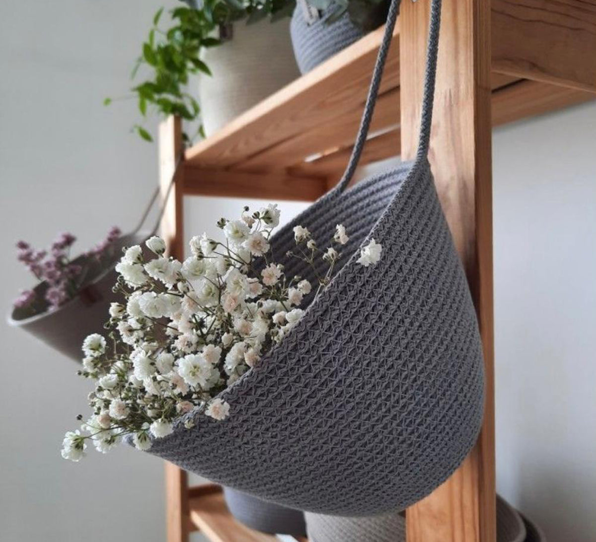 Semi-circular hanging plant holder with a strap
