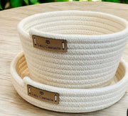 Light-colored round basket with a front leather panel