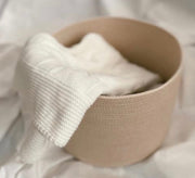 Round basket with a soft weave and a calm muted color