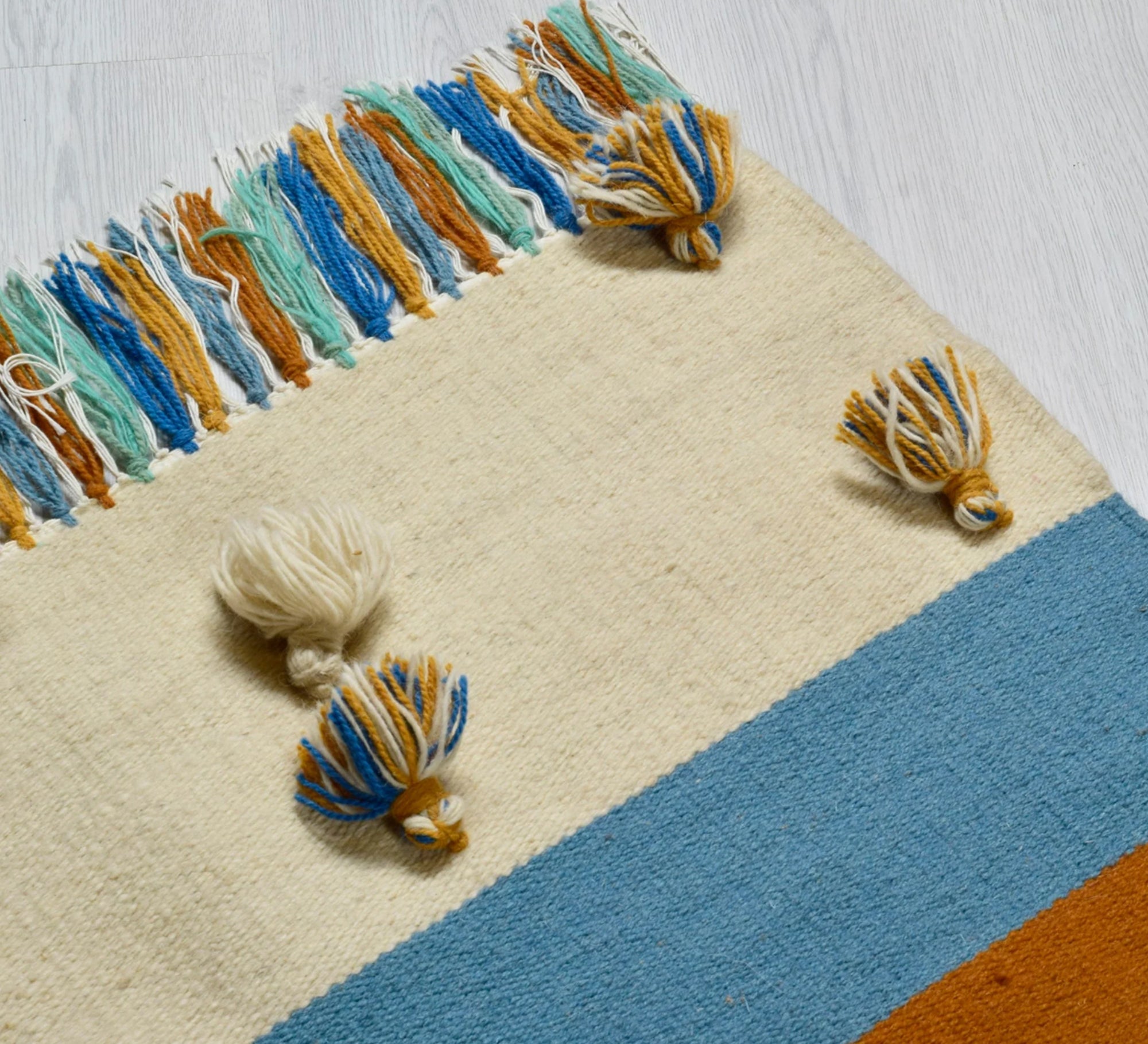 A cheerful and warm bohemian rug featuring stripes, texture, and a nautical hue - Vitrine Furniture - Accessories