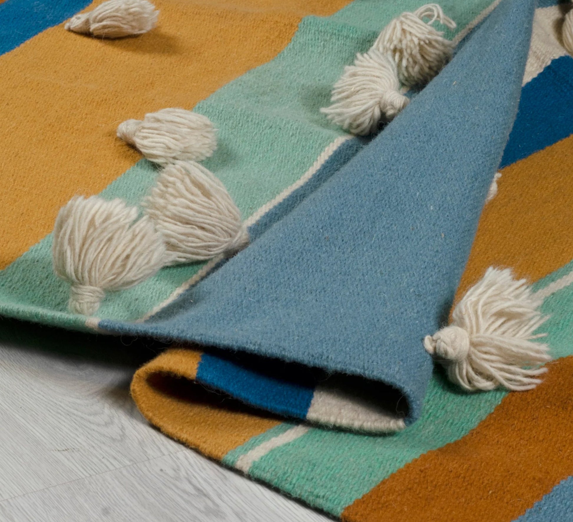 A cheerful and warm bohemian rug featuring stripes, texture, and a nautical hue - Vitrine Furniture - Accessories