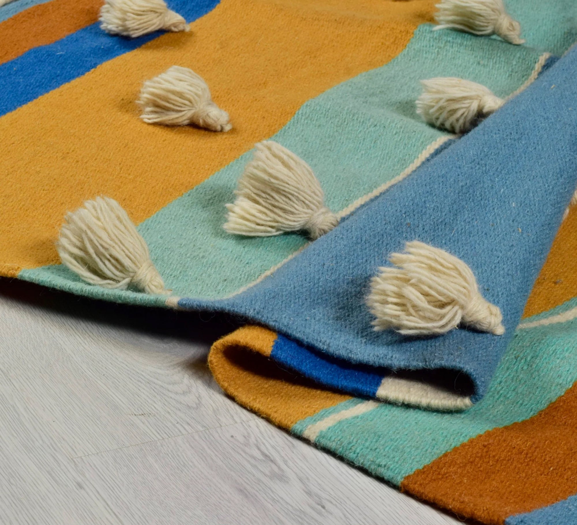 A cheerful and warm bohemian rug featuring stripes, texture, and a nautical hue - Vitrine Furniture - Accessories