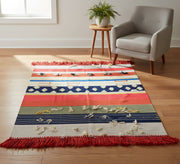 A rug with colorful horizontal stripes in scattered patterns and red tassels. - Vitrine Furniture - Accessories
