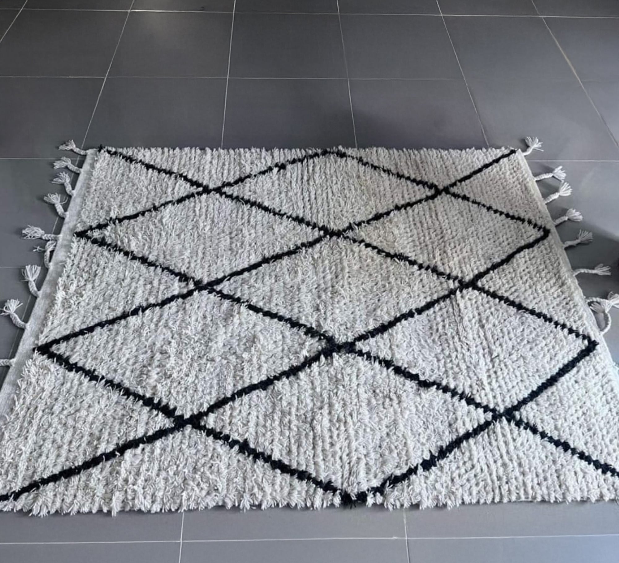 A shaggy white rug with a bold black diamond pattern - Vitrine Furniture - Accessories