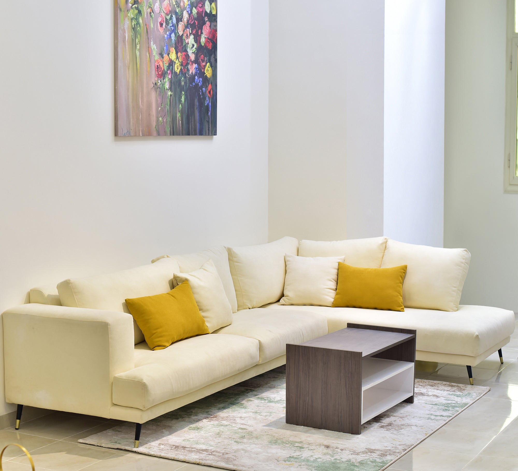 Beige living room corner with yellow pillows - Vitrine Furniture - L - shape sofa set