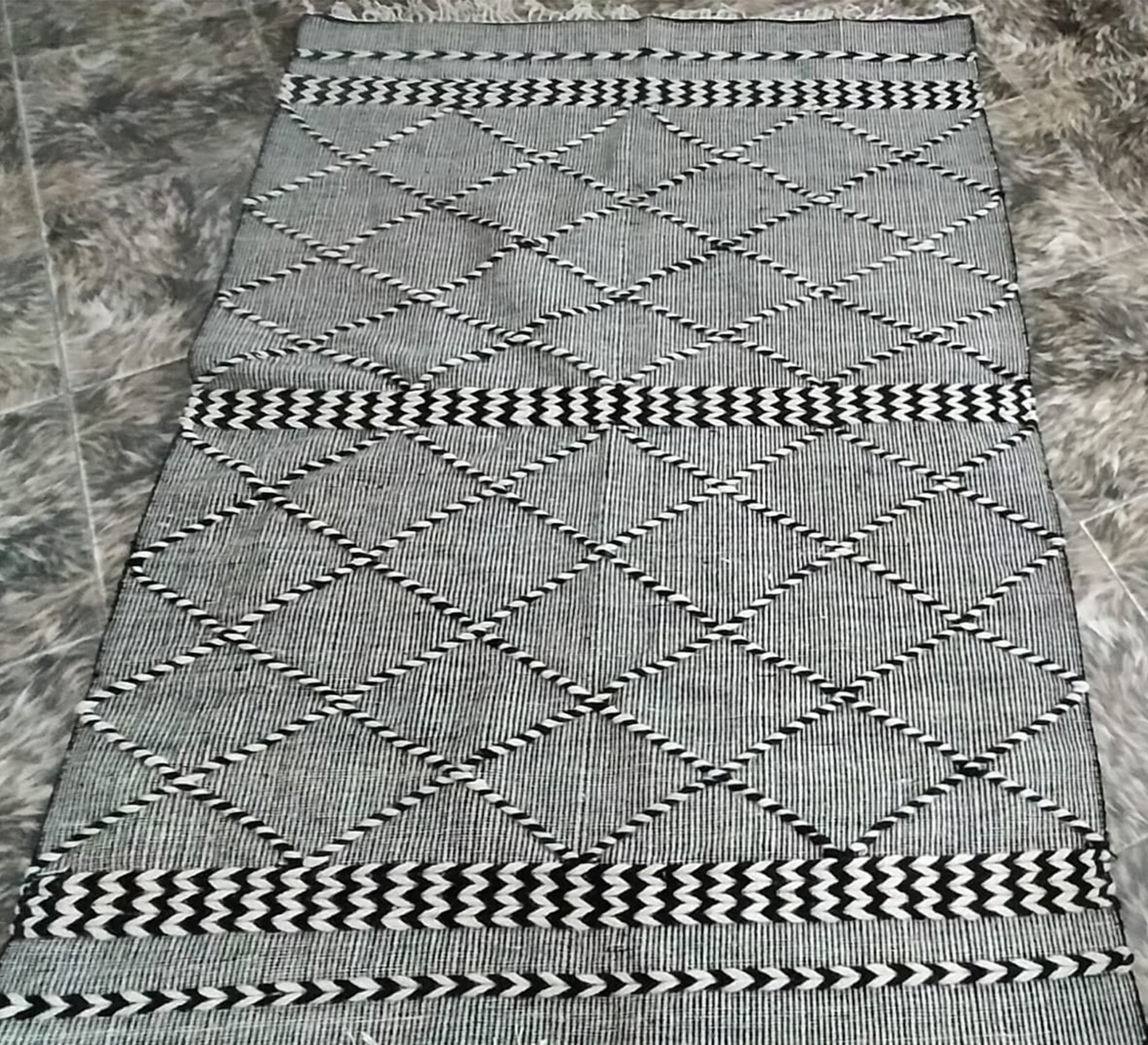 Black and gray rug with a repeating diagonal pattern - Vitrine Furniture - Accessories