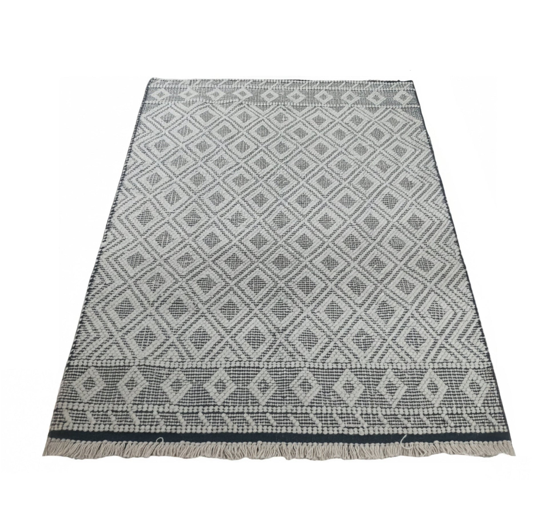 Light - colored rug with a white geometric diamond pattern - Vitrine Furniture - Accessories