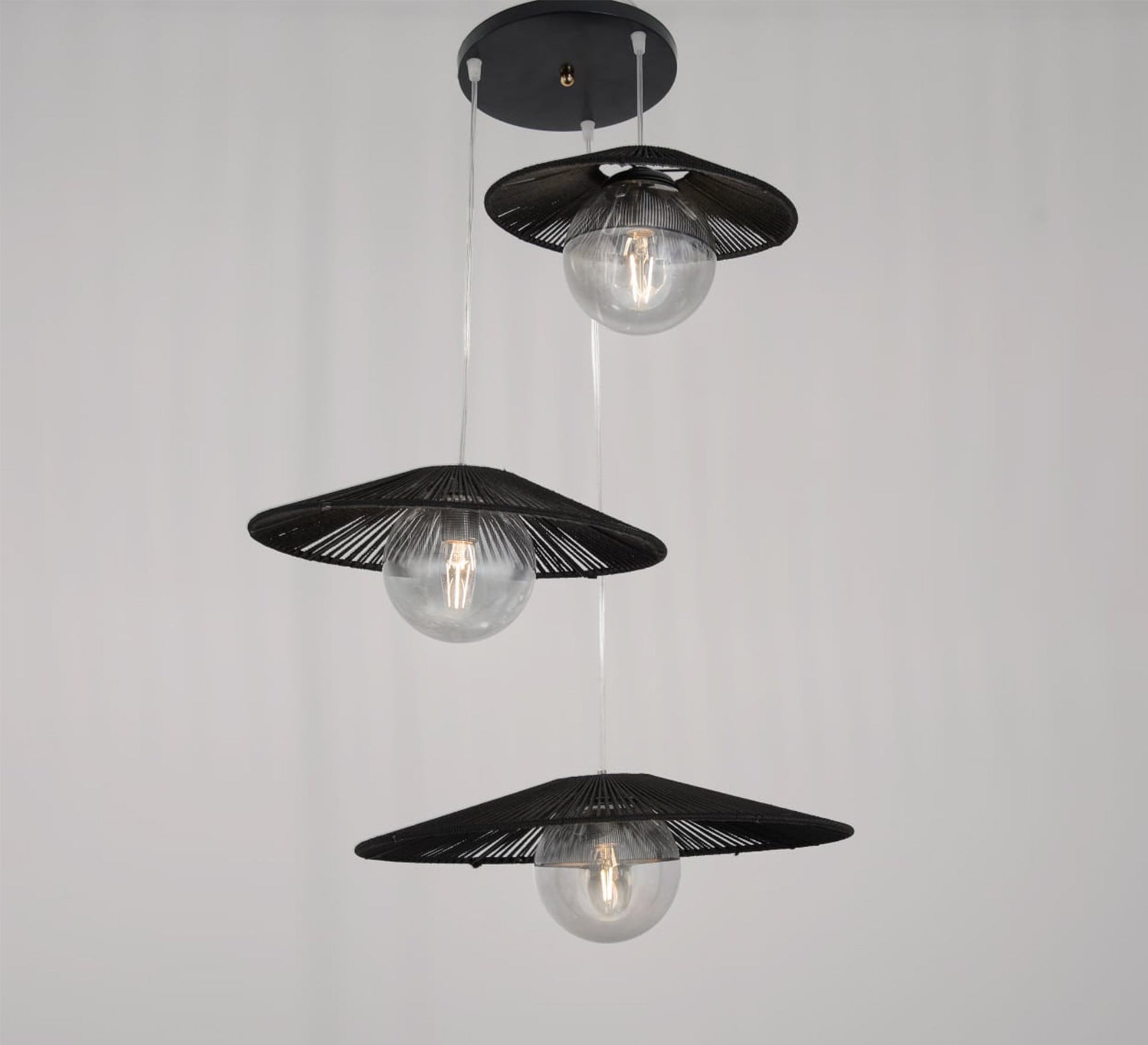 Three - light black pendant lighting at different levels - Vitrine Furniture - Lighting
