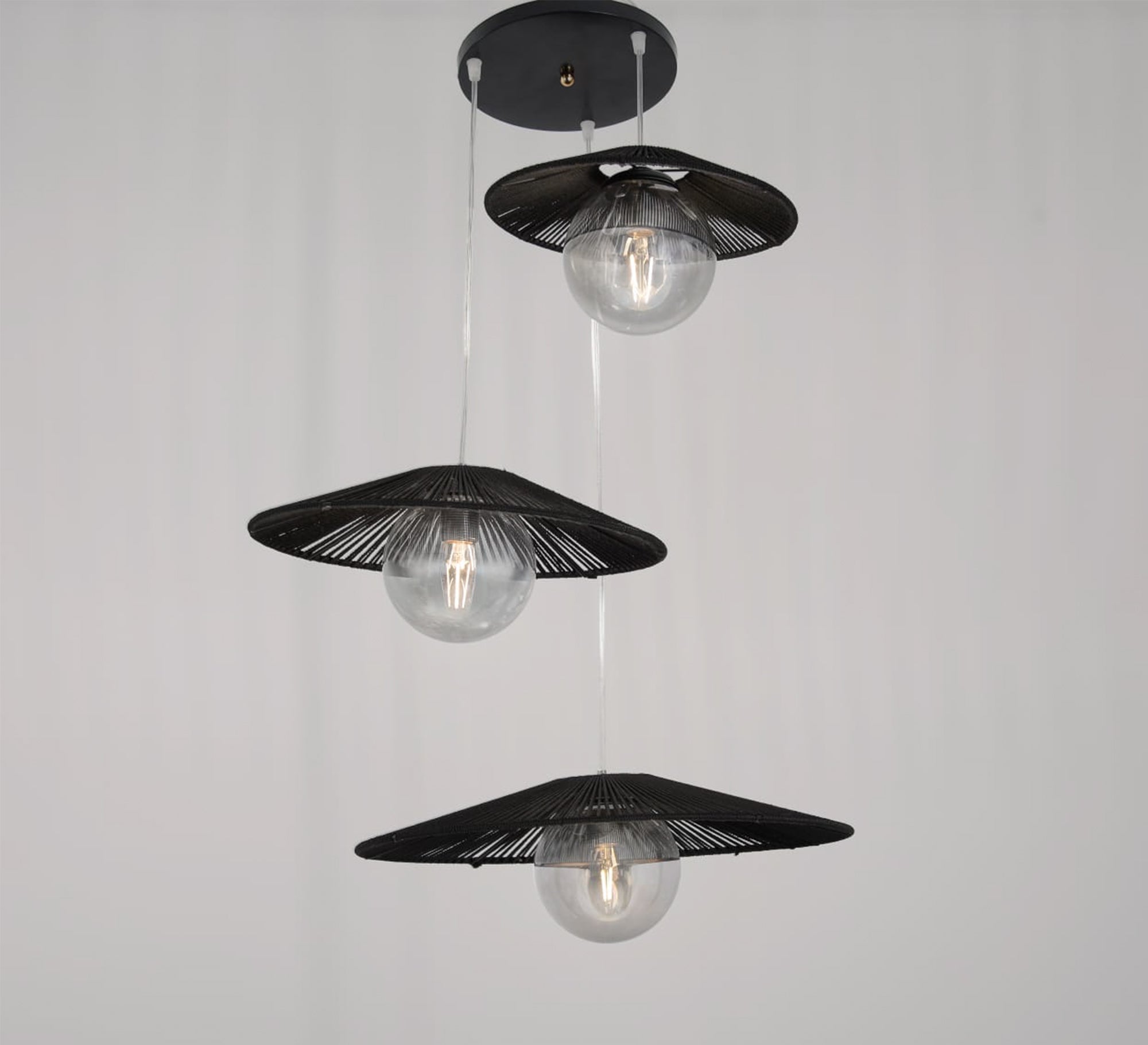 Three - light black pendant lighting at different levels - Vitrine Furniture - Lighting