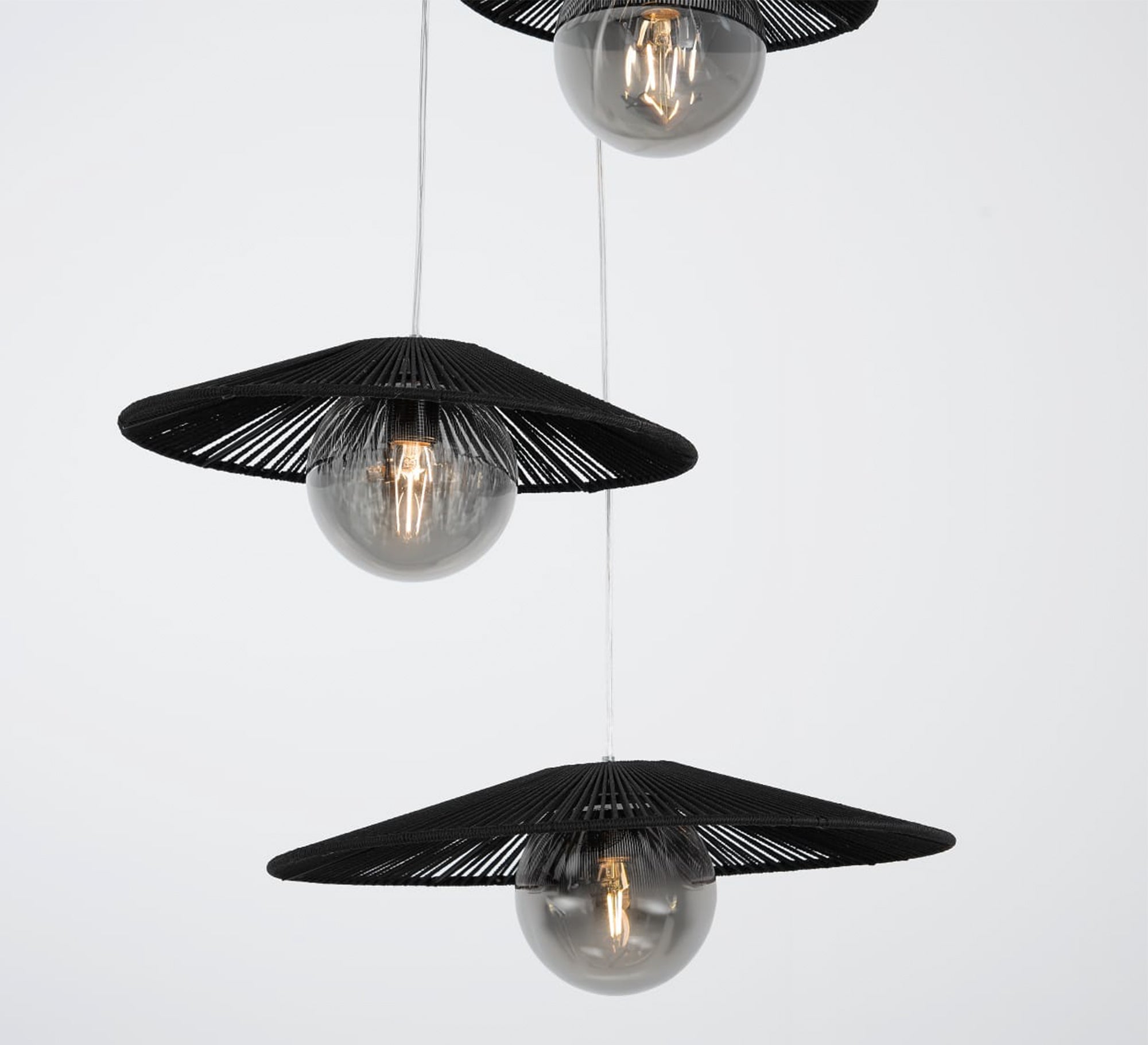 Three - light black pendant lighting at different levels - Vitrine Furniture - Lighting